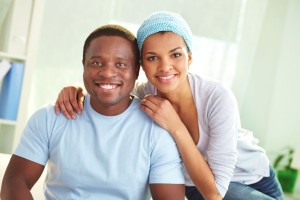 Image of young African couple looking at camera with smiles